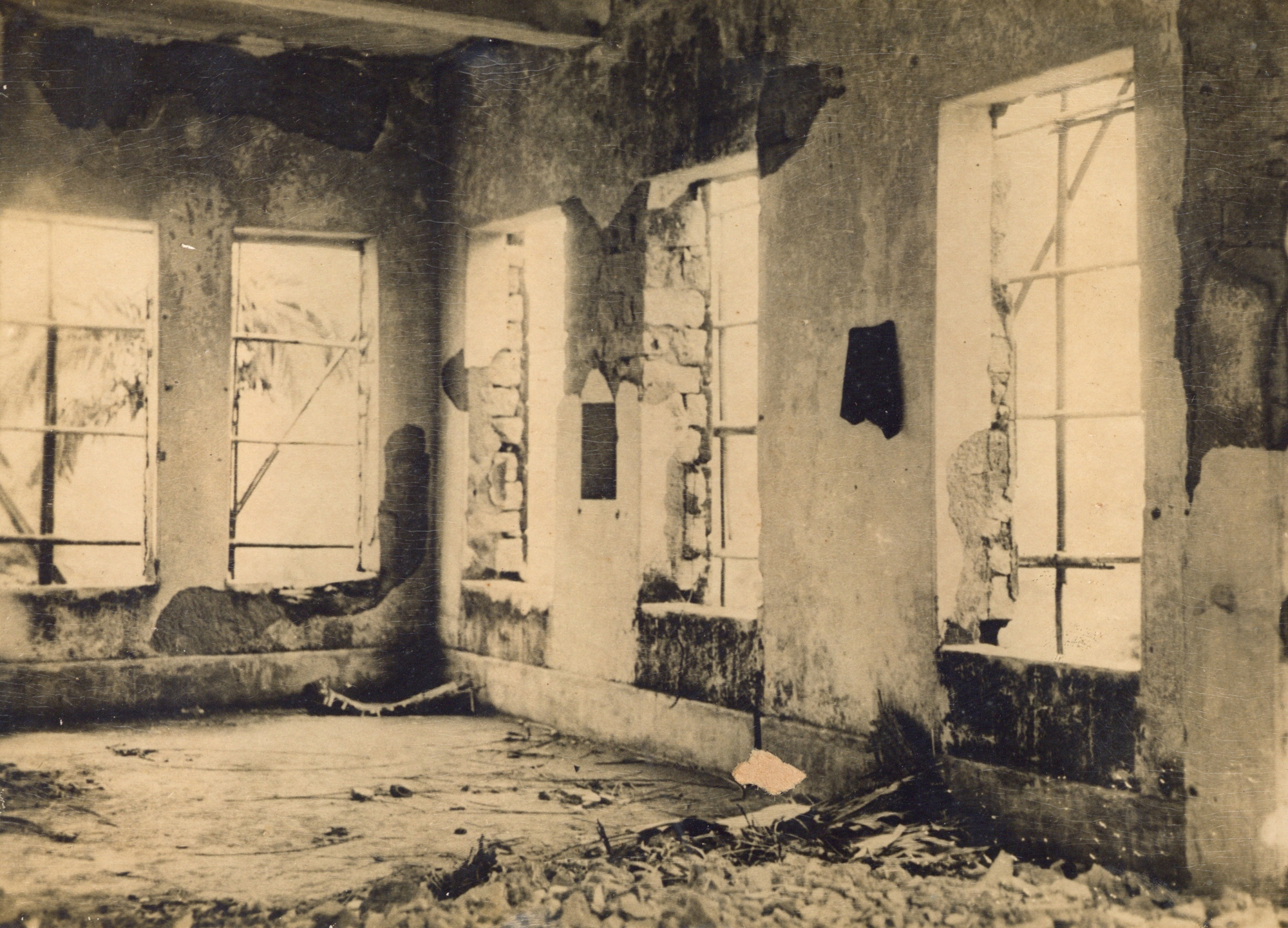 Interior of main building with ruined walls and stolen windows reviewing  the devastation during Japanese Occupation