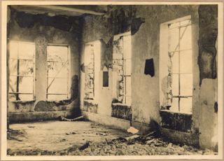 Interior of main building with ruined walls and stolen windows reviewing  the devastation during Japanese Occupation